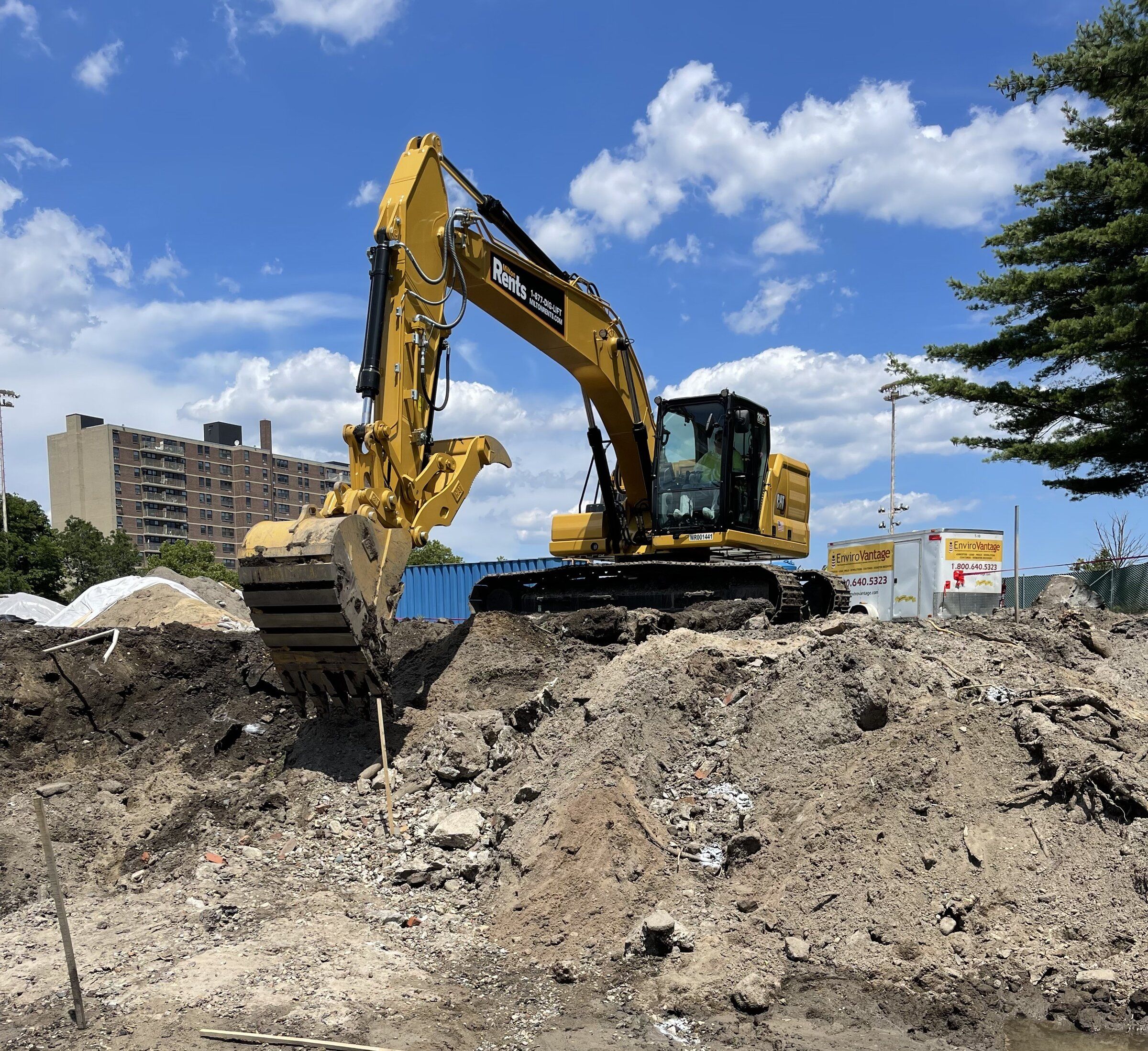 Excavator working on top of a soil stockpile at the West Lynn sewer separation site
